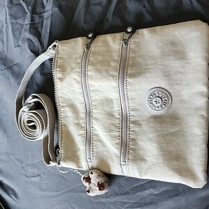 Well loved Kipling gray crossbody purse with‎ gorilla charm
